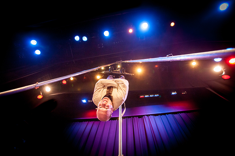 Ian Stewart performing on stage in a white jacket